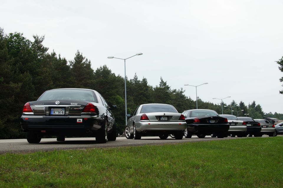 Several Mercury Marauders lined up on a road, seen from behind