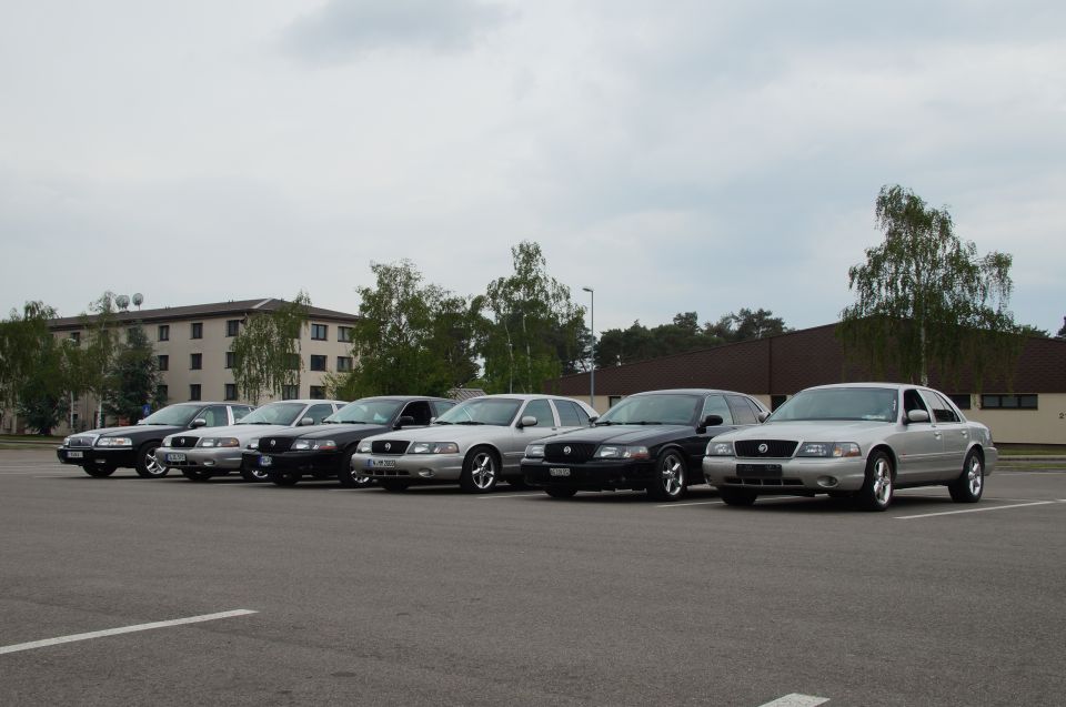 Several Mercury Grand Marquis sedans parked in a lot