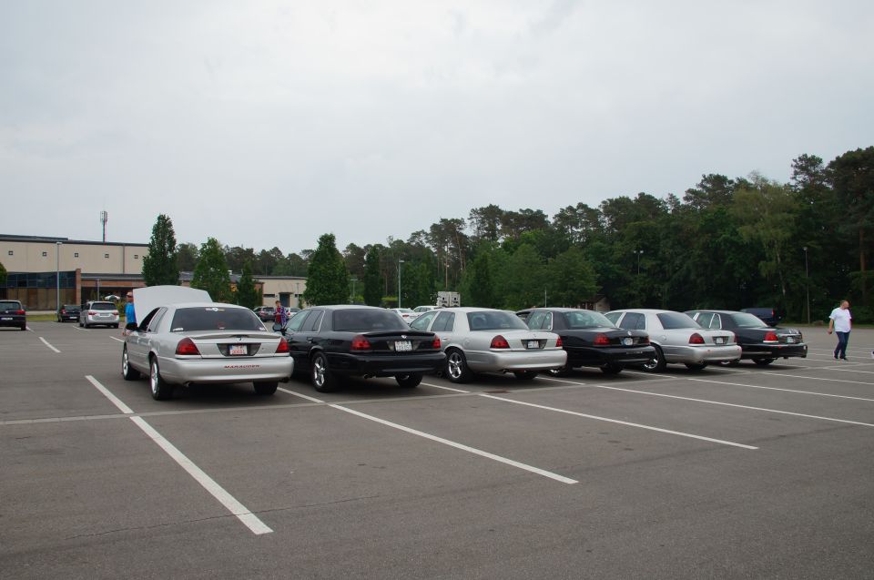 Silver 2003 Mercury Marauder with hood open, parked in a line of sedans