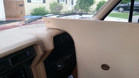1985 Ford Bronco - Interior view of a tan dashboard and center console area of a Ford Bronco, with a portion of the passenger side removed or being worked on.…