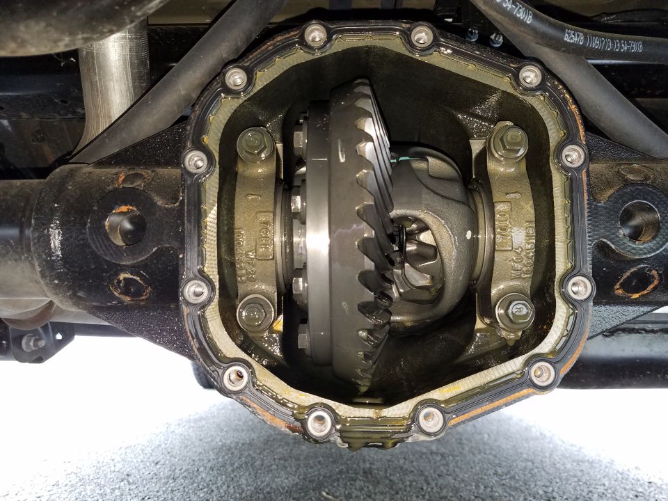 Open rear differential housing with ring and spider gears visible.