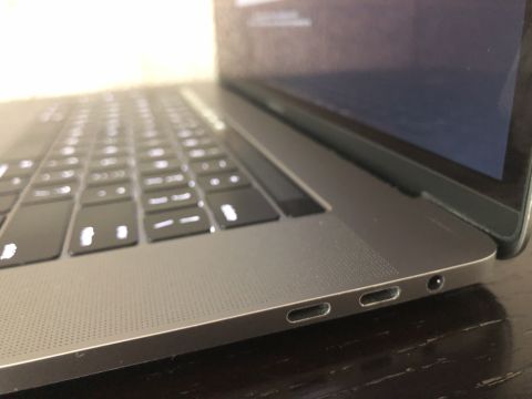 1989 Ford Bronco - A close-up, low-angle shot of the side of a silver laptop, showing a portion of the keyboard and ports.