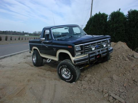 1985 Ford Bronco - This 1985 Ford Bronco, with its distinctive two-tone paint, is positioned on a mound of dirt.