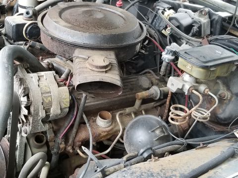 2001 Ford Crown Victoria - Photograph of an engine bay with air cleaner and carburetor, not a technical document.