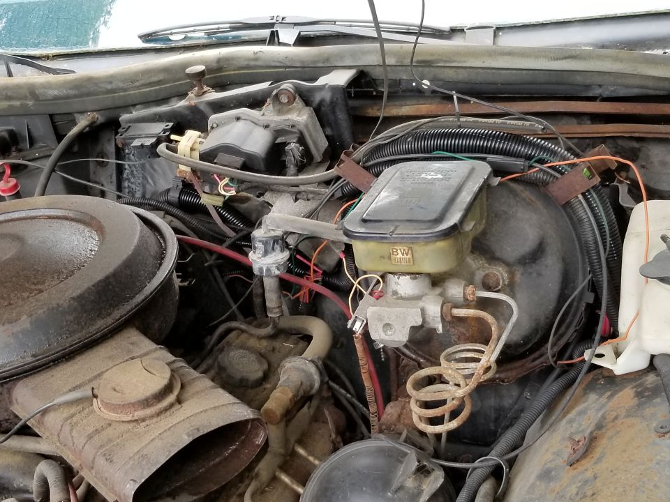 Engine bay photo with air cleaner, distributor and emissions plumbing