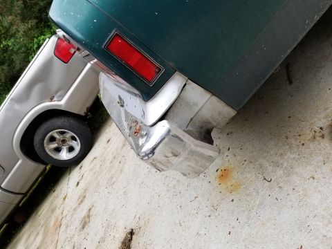 2001 Ford Crown Victoria - Photograph of a sedan rear bumper and taillight, not a technical document.
