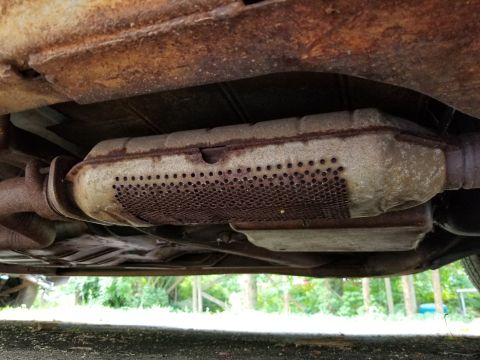 2001 Ford Crown Victoria - Photograph of a catalytic converter under the vehicle, not a technical document.