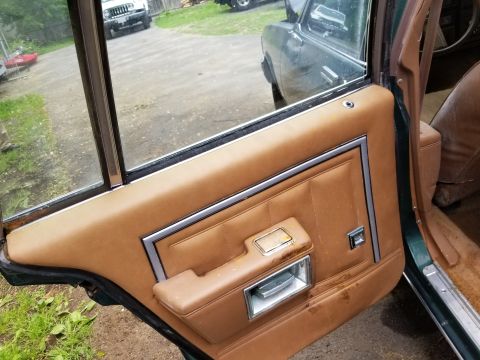 2001 Ford Crown Victoria - Photograph of a vehicle interior door panel, not a technical document.