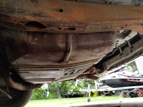 2001 Ford Crown Victoria - Photograph of a vehicle undercarriage and fuel tank, not a technical document.