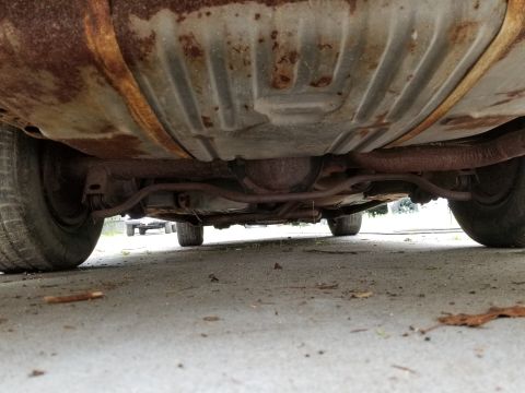2001 Ford Crown Victoria - Photograph of a vehicle's underbody and rear axle, not a technical document.