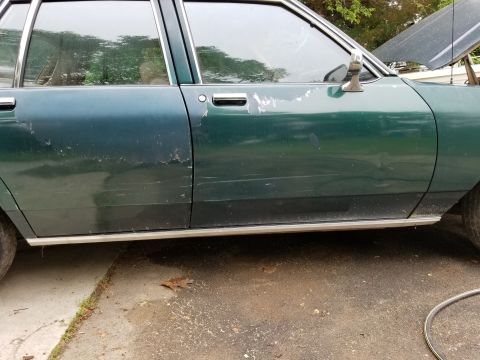 2001 Ford Crown Victoria - Photograph of a vehicle's side body and doors, not a technical document.