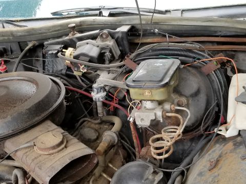 2001 Ford Crown Victoria - Close-up view of the engine bay, showing the brake master cylinder, air cleaner housing, and various hoses and wiring.