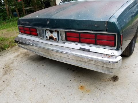 2001 Ford Crown Victoria - This Chevrolet Caprice shows its rear end, a chrome bumper and dual rectangular taillights.