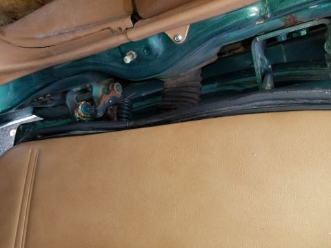 2001 Ford Crown Victoria - Close-up view of a vehicle's door hinge mechanism, showing signs of rust and a protective bellows.