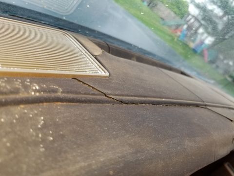 2001 Ford Crown Victoria - Interior view of a cracked dashboard, with a speaker grille visible.