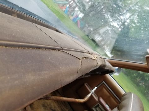 2001 Ford Crown Victoria - Interior view of a cracked dashboard with a metal tube protruding.