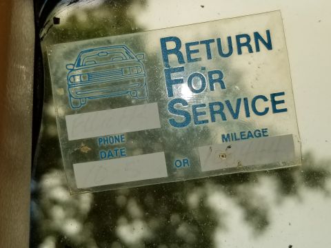 2001 Ford Crown Victoria - Dealer service-reminder windshield sticker reading 'Return For Service' with blank phone, date and mileage fields.
