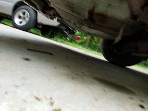2001 Ford Crown Victoria - The underside of a vehicle is shown, with a second vehicle visible in the background.