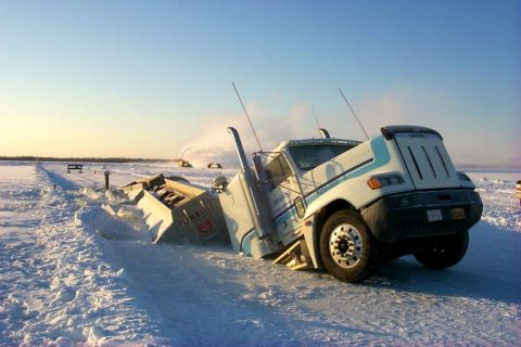 1979 Ford Bronco - A semi-truck is stuck in a snowy landscape, with snowplows visible in the distance.