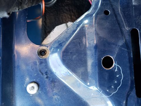 1989 Ford Bronco - Detail of a blue metal panel showing mounting points and holes.