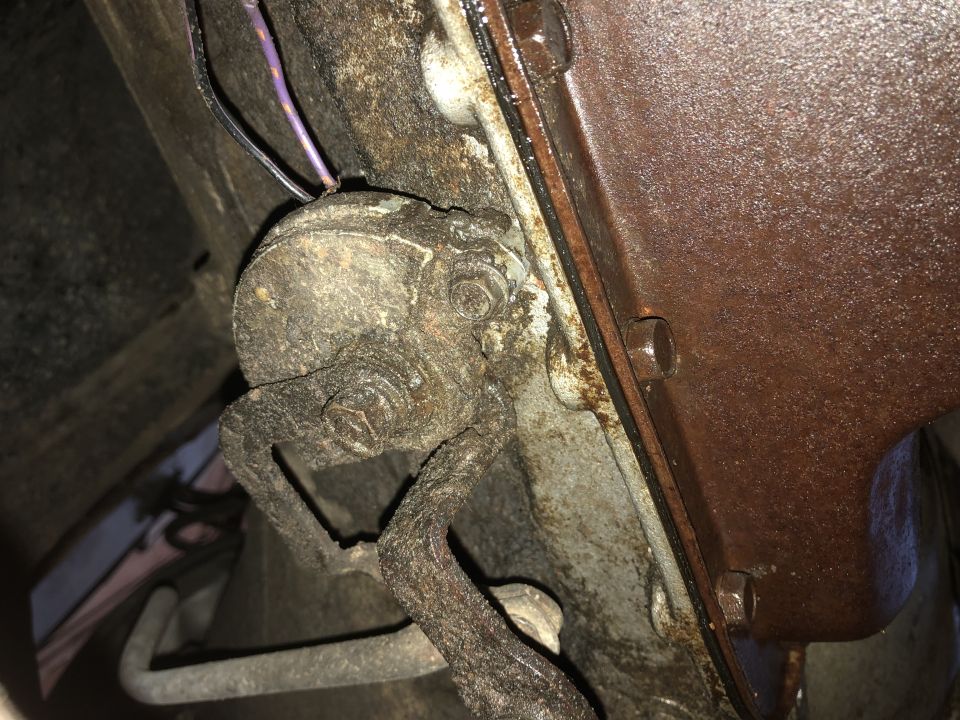 Rusty transmission part with wiring and a Supermotors.net watermark
