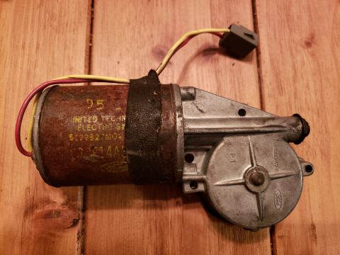1989 Ford Bronco - This part is a Ford windshield wiper motor. It has visible part numbers and the Ford logo stamped on its casing.