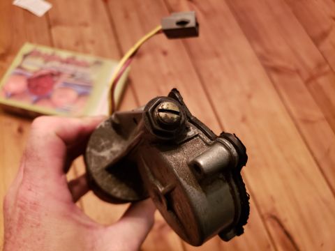 1989 Ford Bronco - Close-up of an automotive part held in a hand, with wires and a connector visible.