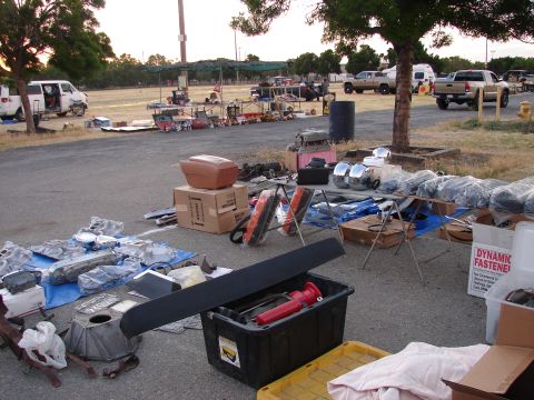 1973 Ford Ranchero - Various automotive parts are displayed for sale at an outdoor market.