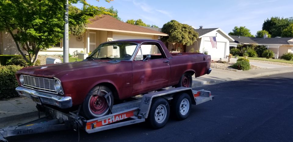 Red 1966 Ford Ranchero on U-Haul trailer, front 3/4 view