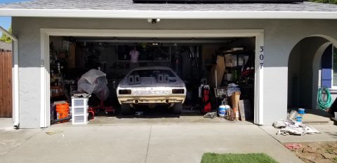 1974 Plymouth Duster - Rear view of a 1974 Plymouth Duster in a garage, appearing to be in the middle of restoration work.