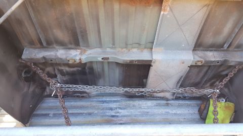 1965 Ford Mustang - The underside of a truck bed shows a frame with chains secured to it, possibly for cargo.