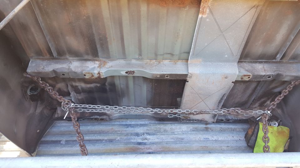view of truck bed underside with chains attached to frame