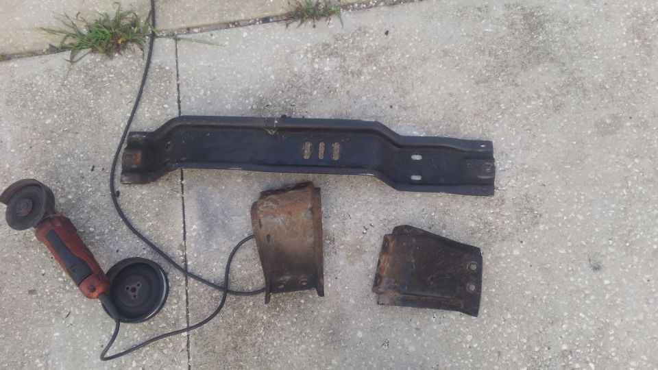 this is the stock crossemember of the F250. it was originally for a 4x4 AOD and all i did was move it back an inch or so for the 4R70W swap. despite the transmissions being very similar and using the same transfer case as the original, the front driveshaft interfered quite alot of it. 

i experimented with a few ways to take care of this but nothing would give enough clearance for without causing other issues. i decided i would go ahread and cut and weld the crossmeember with a dropped section to have clearance. i may change the crossemember in the future but i needed something to hold the transmission for now