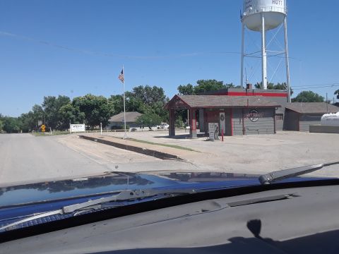 1994 Ford Bronco - Gas station and water tower in Hoyt, Kansas, seen from the perspective of a vehicle's interior.