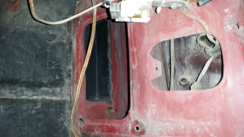 1985 Ford Bronco - Detail of a vehicle's interior panel, showing wiring and access holes.