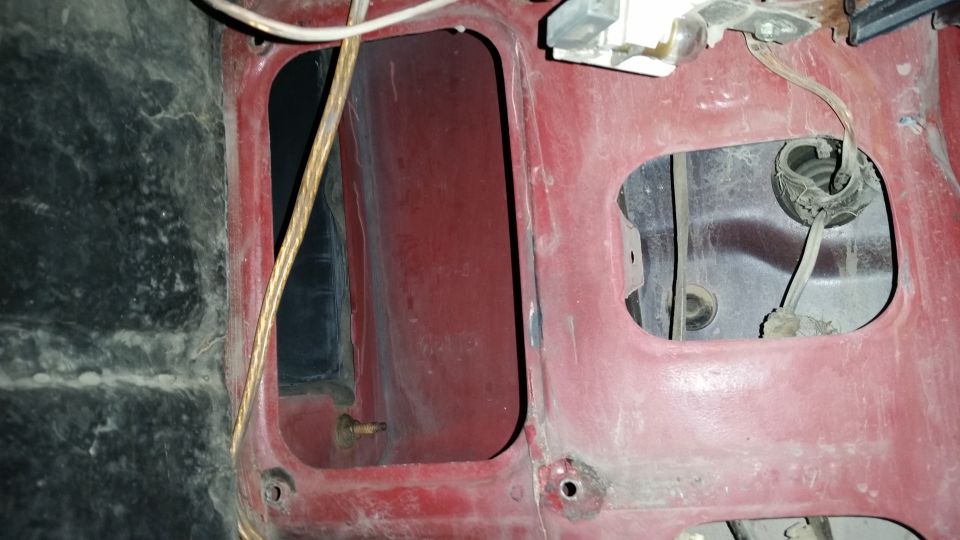 Red interior paneling with cutouts for wiring and components