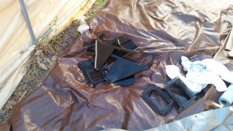 1985 Ford Bronco - Interior trim pieces are spread out on a tarp, possibly for restoration or cleaning.
