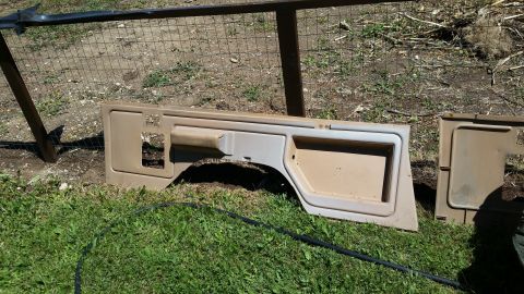 1985 Ford Bronco - Interior door panel and trim piece are shown outdoors, likely for restoration or replacement.