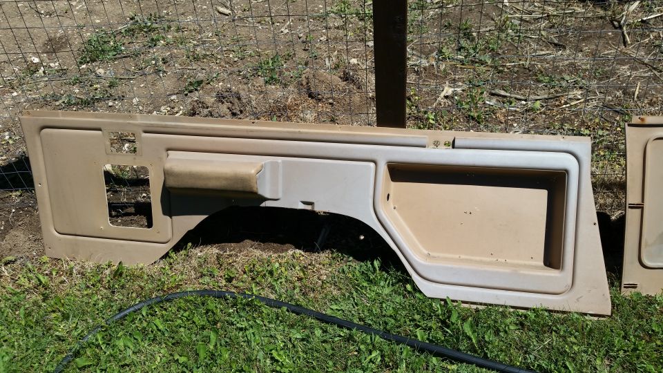 Tan interior door panels laid on grass