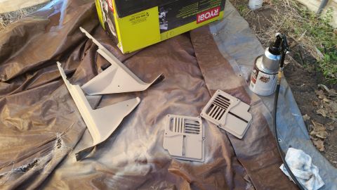 1985 Ford Bronco - Interior trim parts are prepared for a fresh coat of paint, alongside a spray gun and a Ryobi tool box.