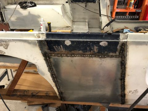 1992 Jeep Wrangler - A section of a vehicle's body is shown with fresh metal patch panels welded into place, likely a repair or modification. The area appears t…
