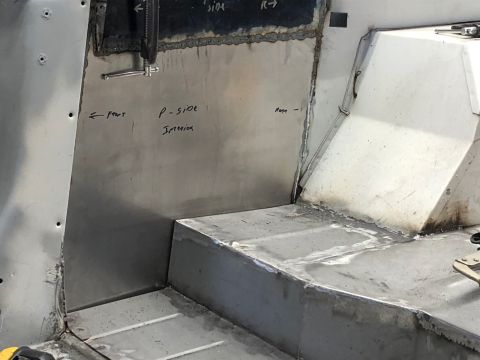 1992 Jeep Wrangler - The interior of a vehicle undergoing fabrication, showing newly welded sheet metal panels on the floor and side wall. Handwritten labels in…