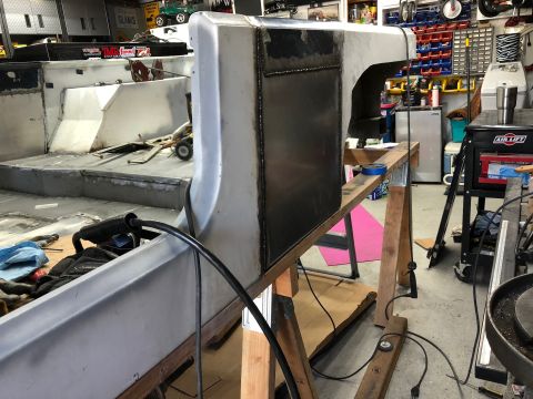 1992 Jeep Wrangler - A custom-built vehicle body, likely a Jeep, is in a workshop setting. The unfinished metal body is supported by wooden sawhorses and shows…