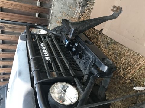 1987 Suzuki Samurai - Photograph of a Suzuki front end with mounted hitch, not a technical document.