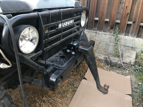 1987 Suzuki Samurai - Photograph of a Suzuki front end with a hitch, not a technical document.