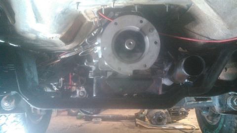 1992 Ford Bronco - The underside of a vehicle shows a transmission and exhaust system, with a portion of the frame and suspension visible. A red wire runs alo…