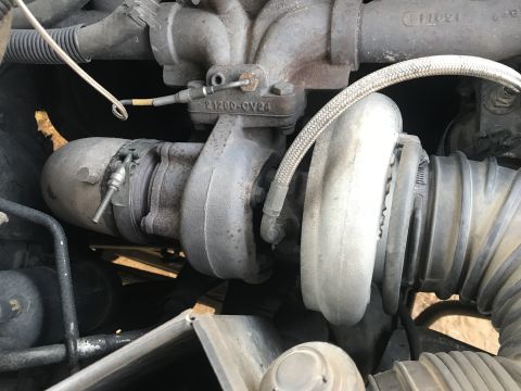 1997 Dodge 3500 - A close-up view of a turbocharger and associated plumbing on a Dodge 3500 engine. Visible text on the turbocharger reads "21200-GV24".