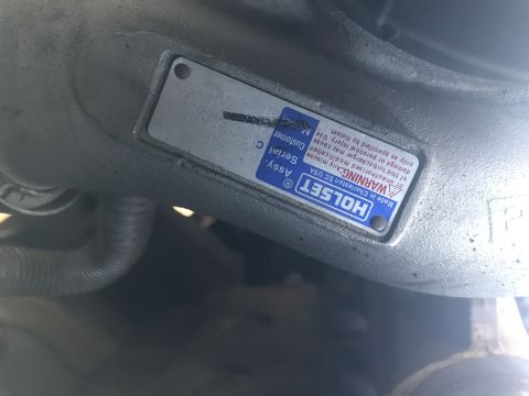 1997 Dodge 3500 - Manufacturer ID plate on a Holset turbocharger listing the assembly serial number and a warning notice.