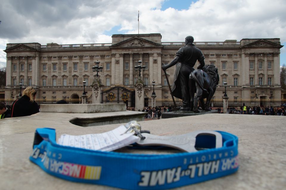 Blue NASCAR Hall of Fame lanyard in foreground with Buckingham Palace in background.