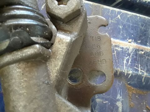 1996 Ford F-350 - Close-up of a metal part with stamped codes and a website logo visible.